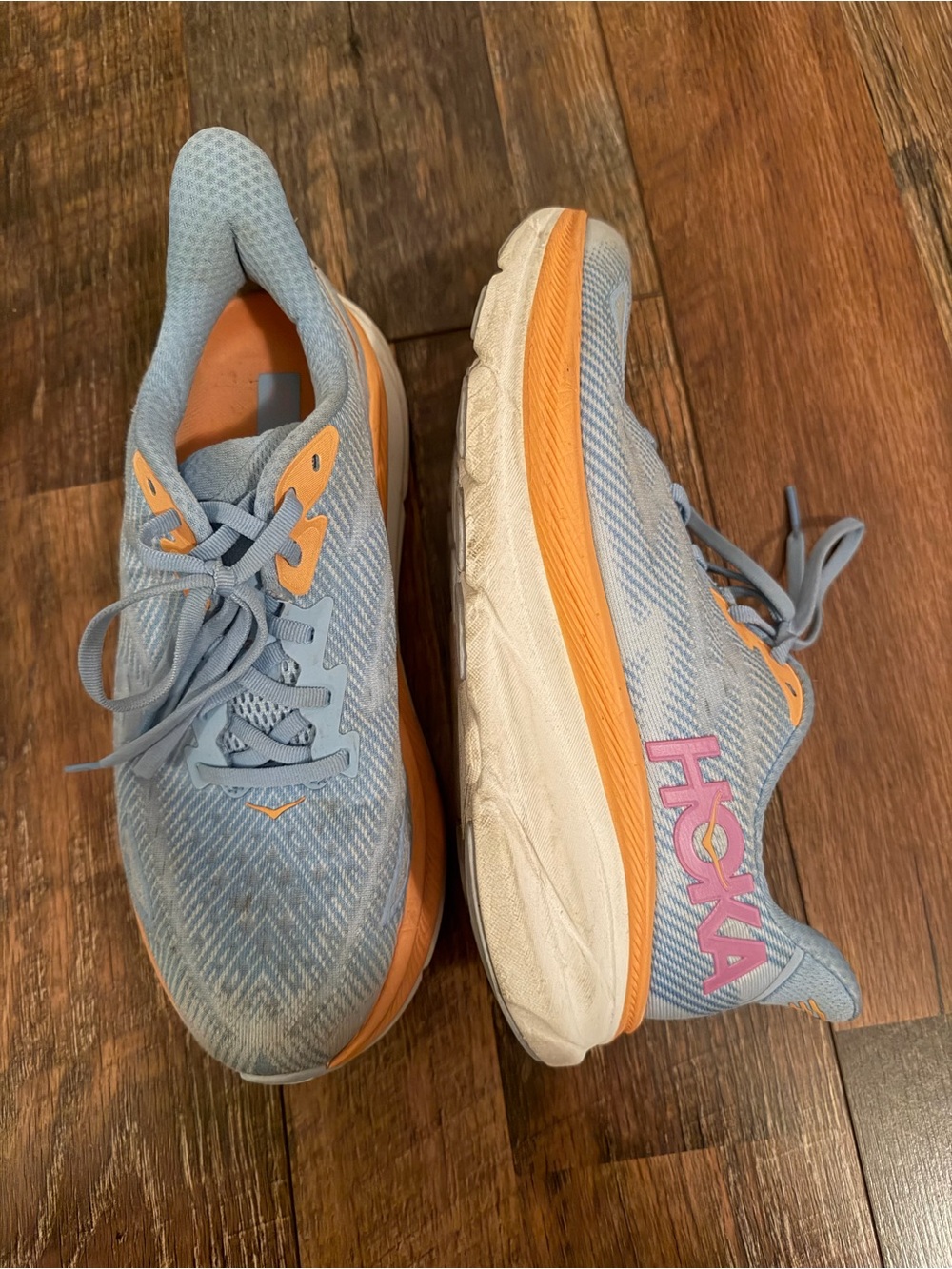 Hoka Light Blue Running Shoes with Orange Accents and Pink Logo